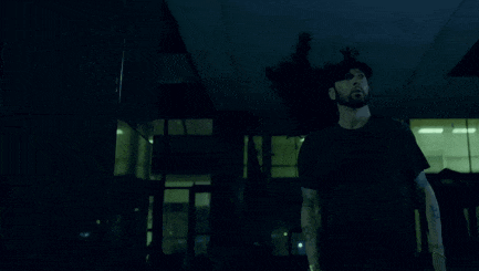 a person is standing in front of a building with a broken ceiling .