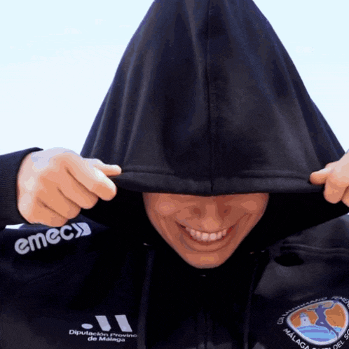 a person wearing a hoodie that says emec on the front