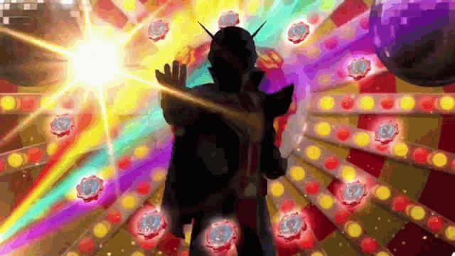 a man in a mask is standing in front of a disco ball with a rainbow of lights behind him .