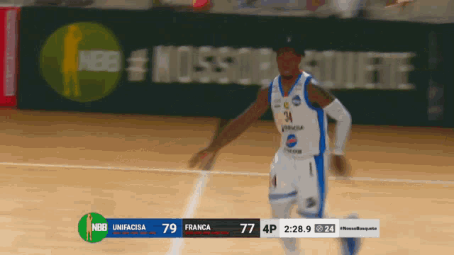a basketball player with the number 34 on his jersey runs on the court