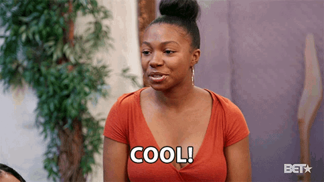 a woman in an orange shirt says cool in black letters