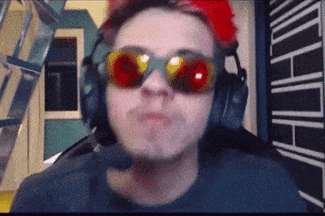 a man wearing headphones and sunglasses has a red eye