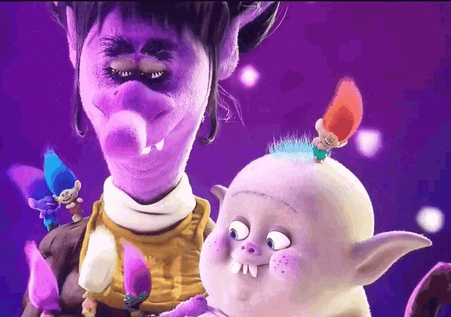 two trolls are standing next to each other with one having a purple face