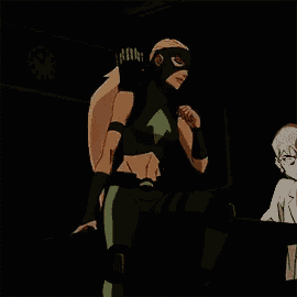 a woman in a green arrow costume is standing next to a man in a white lab coat .