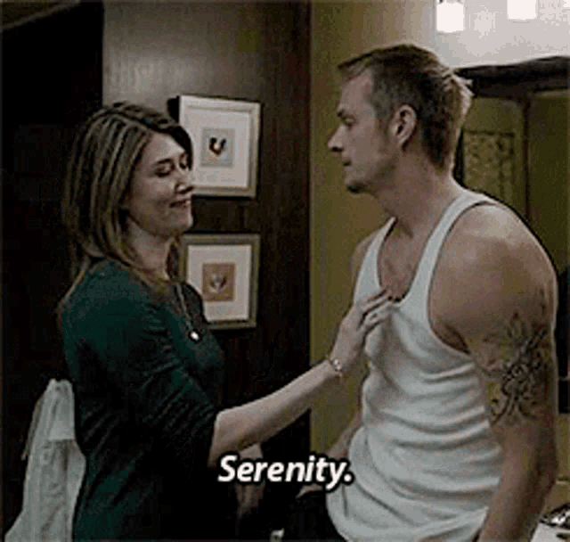 a man and a woman are standing next to each other and the woman is touching the man 's shirt .