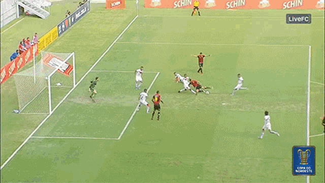 a soccer game is being played on a field that has a live fc logo