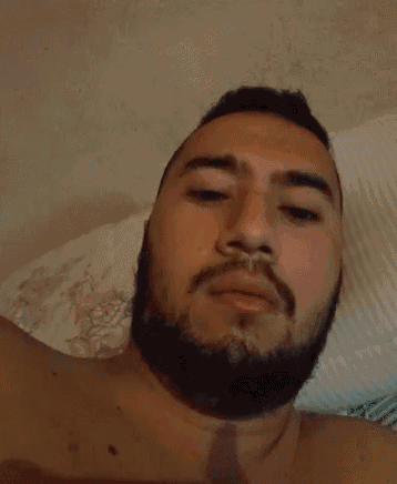 a shirtless man with a beard is taking a picture of himself