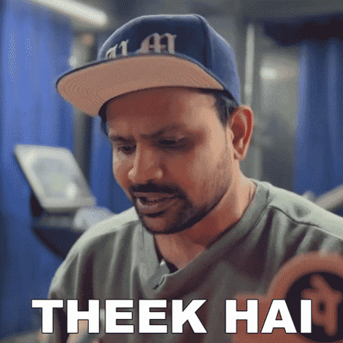 a man wearing a hat with the word theek hai written on it