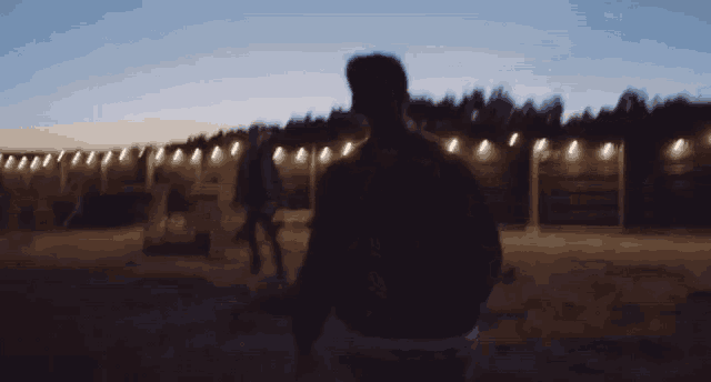 a blurry picture of a man walking at night