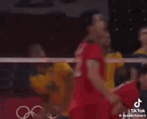 a group of volleyball players are playing a game of volleyball .
