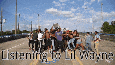 a group of people are dancing on a highway with the words listening to lil wayne