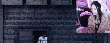 a woman wearing headphones is sitting in front of a wall