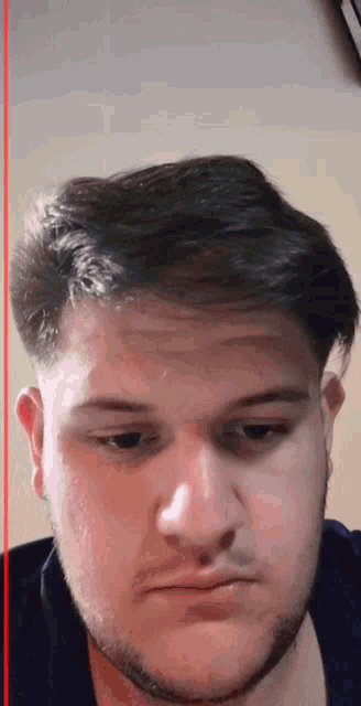 a close up of a man 's face with a red line on the bottom