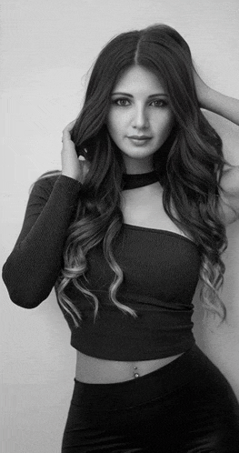 a black and white photo of a woman wearing a choker