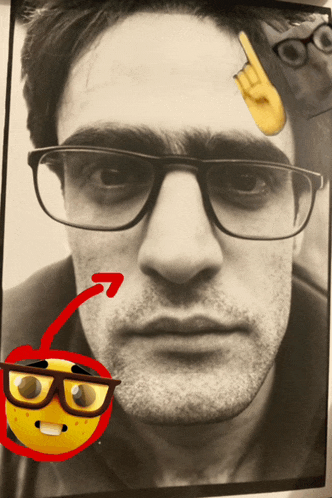 a black and white photo of a man wearing glasses and a smiley face
