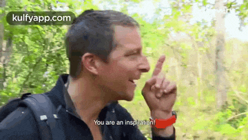 a man with a backpack is making a gesture with his finger and says `` you are an inspiration ! ''