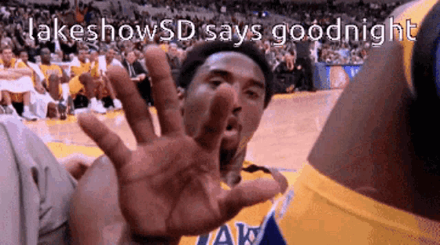 a basketball player says goodnight in front of a crowd of people