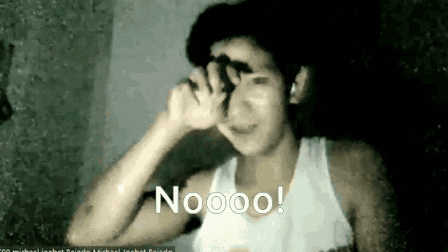 a man in a white tank top is covering his face with his hand and the word nooo is on the bottom