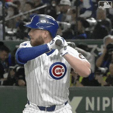 a cubs baseball player is getting ready to hit the ball