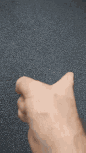 a close up of a person 's fist on a carpet .