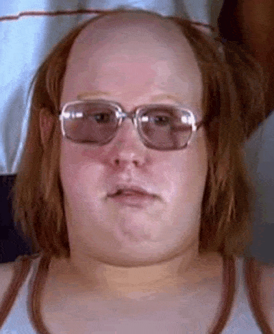 a bald man wearing glasses and a tank top .