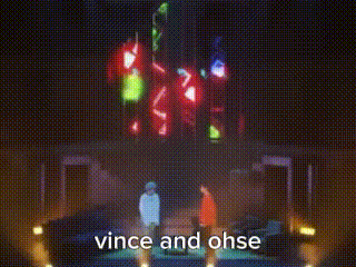 two people are standing in front of a large screen that says " vince and ohse "