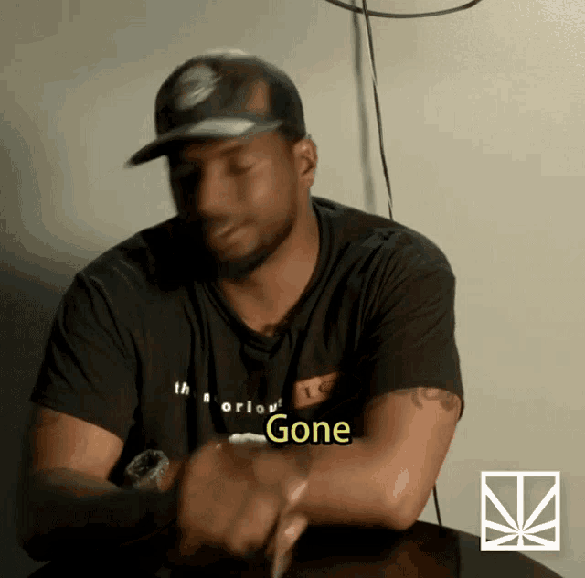 a man wearing a black shirt that says " gone "