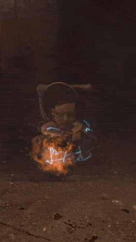 a person is laying on the ground with a fire coming out of their mouth