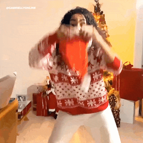 a person wearing a red and white sweater with snowflakes on it