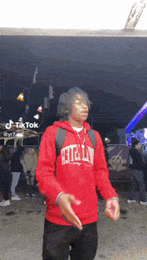a man wearing a red hoodie that says atlanta on it