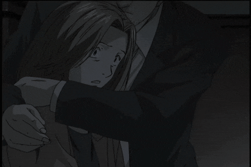 a man in a suit and tie is hugging a woman