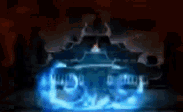 a person is standing in front of a castle with a blue light coming out of it in a dark room .