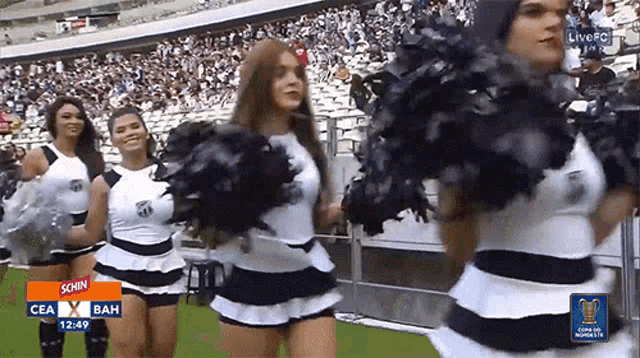 cheerleaders are dancing in front of a screen that says schn on it