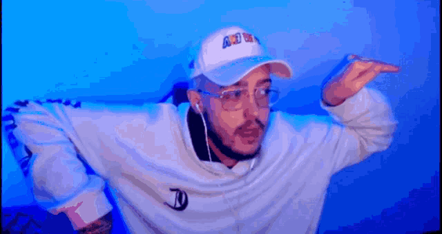 a man wearing a white hat that says a.d.w. on it