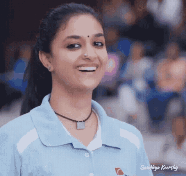 a girl wearing a blue shirt with the name sandhya keerthy on it