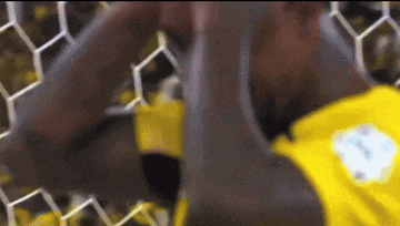 a man in a yellow shirt with the number 1 on the back