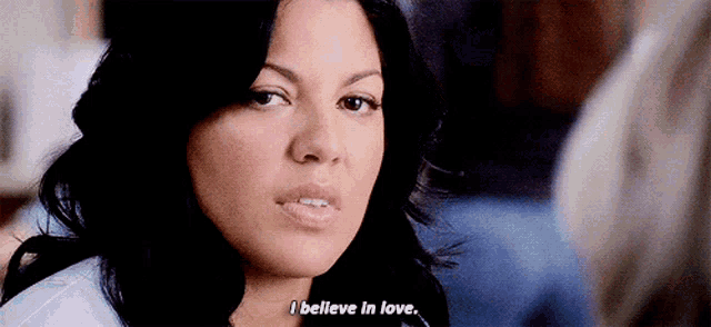 a close up of a woman 's face with the words " i believe in love "