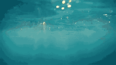 a blurred image of a body of water with a yellow light shining through it