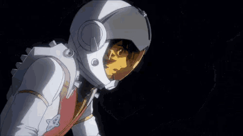 a man in a space suit with a helmet on is standing in a dark room .
