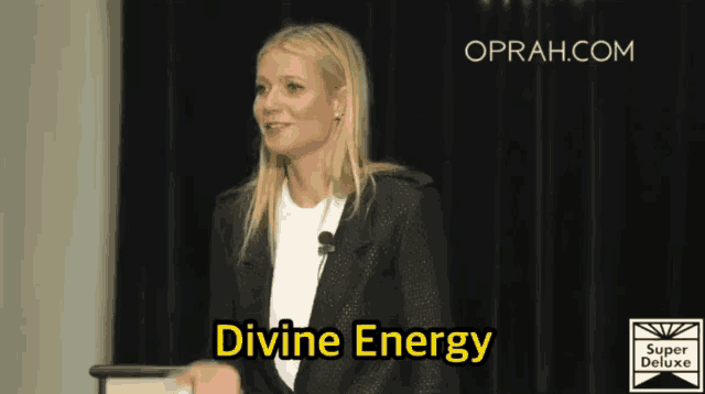 a woman stands at a podium with divine energy written on her face
