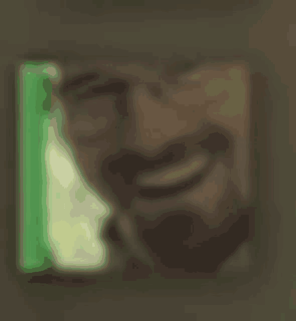 a blurry picture of a man with glasses smiling