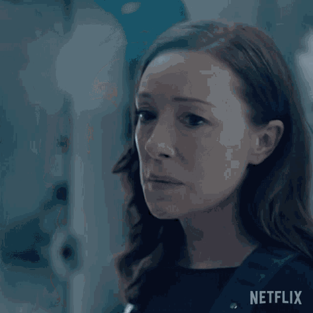 a close up of a woman 's face with a netflix logo in the background .