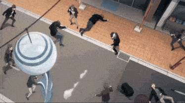 a group of people are standing on a sidewalk in a city .