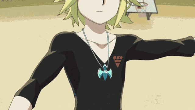 a boy wearing a black shirt with a red triangle on it
