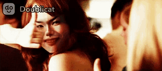 a woman making a funny face with the words doublicat written above her