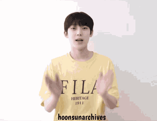 a young man wearing a yellow fila shirt