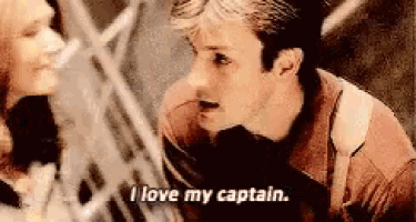 a man and woman are talking to each other and the man is saying `` i love my captain '' .