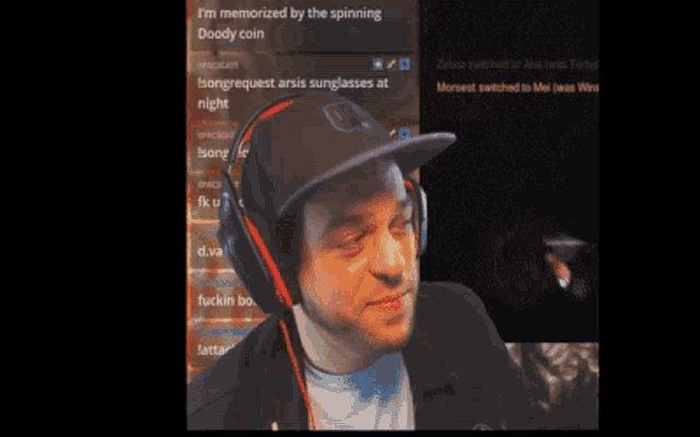 a man wearing headphones and a hat says i 'm memorized by the spinning doody coin