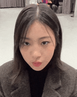 a close up of a woman 's face with a serious look on her face
