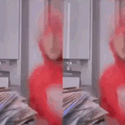 a man in a red hoodie is sitting in front of a pile of money .